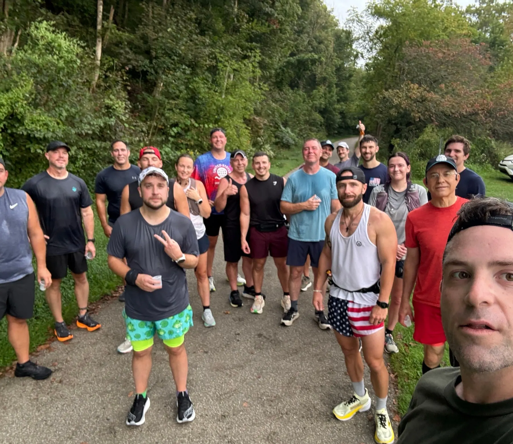 A GRYT Saturday run crew gathered on a wooded trail, smiling at the camera